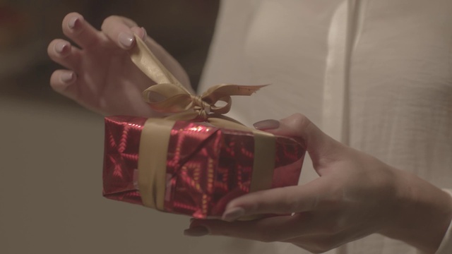 Video Reference: Present, Gift wrapping, Pink, Ribbon, Hand, Material property, Finger, Paper, Party favor