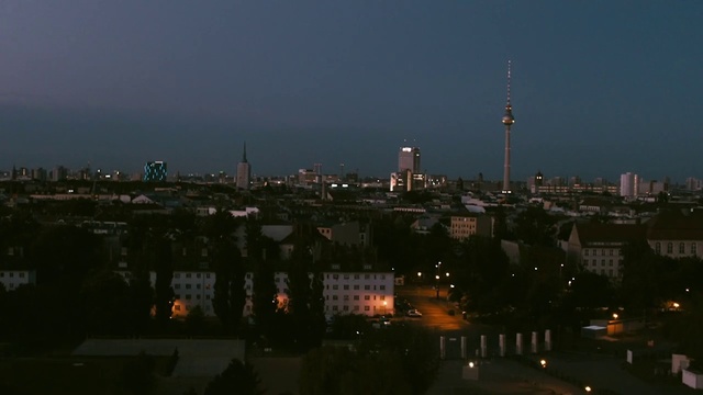 Video Reference: Metropolitan area, Cityscape, City, Night, Urban area, Metropolis, Sky, Skyline, Human settlement, Downtown, Outdoor, Building, Factory, Water, View, Clock, Large, Tower, Street, Boat, Many, Cloudy, River, Traffic, White, Sunset, Bridge, Standing, Group, Skyscraper, Day