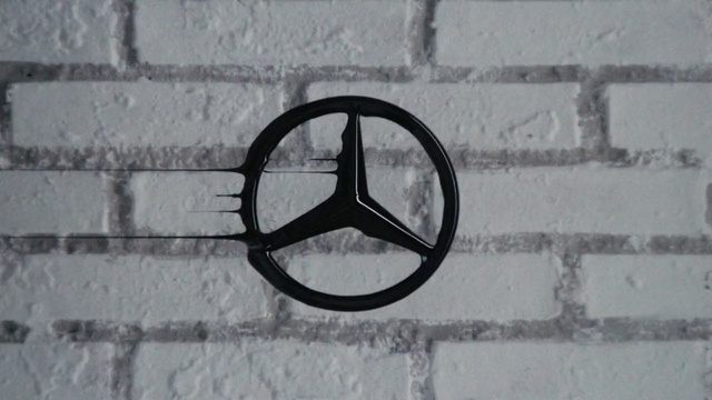 Video Reference: Wall, Symbol, Logo, Peace symbols, Number, Black-and-white, Circle, Peace, Graphics, Metal, Person, Building, Outdoor, Sitting, Street, Black, Bicycle, Man, Side, Walking, Brick, White, Woman, Bench, Window, Standing, Rain, Phone, Sign, Glasses, Stone