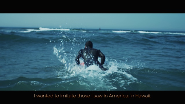 Video Reference: Wave, Water, Wind wave, Surfing, Ocean, Sea, Surfing equipment, Surface water sports, Boardsport, Wetsuit, Outdoor, Riding, Sport, Man, Small, Board, Large, Laying, Black, Young, Catch, Dog, Beach, Yellow, Standing, Woman, White, People, Playing, Swimming, Water sport, Person, Text, Surfboard
