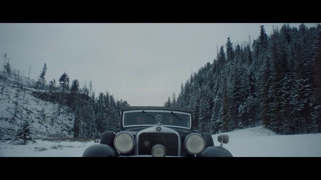 Video Reference: Land vehicle, Vehicle, Car, Vintage car, Classic car, Antique car, Classic, Photography, Snow, Winter, Outdoor, Man, Traveling, Forest, Covered, Riding, Skiing, White, Hill, Red, Driving, Road, Bus, Train, Truck, Standing, Tree, Sky, Text, Auto part, Transport, Day