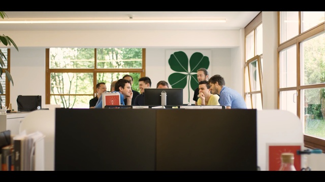 Video Reference: Event, Office, Room, Furniture, Building, Table, Architecture, Interior design, Conversation, Conference hall, Person