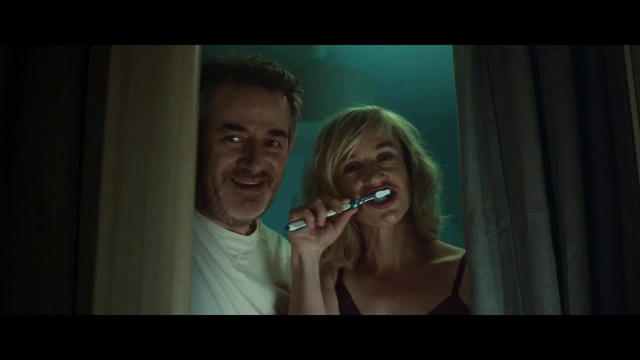 Video Reference: Tooth, Organ, Mouth, Fun, Human body, Jaw, Smile, Photography, Scene, Photo caption, Person, Teeth, Brushing, Indoor, Man, Looking, Woman, Front, Mirror, Green, Photo, Standing, Toothbrush, Dark, Holding, Girl, Using, Smiling, Young, Food, Brush, Phone, Room, White, Human face, Music, Face, Portrait, Screenshot