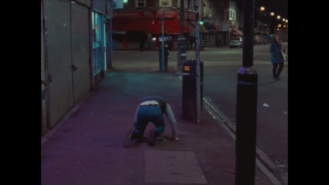 Video Reference: Blue, Red, Mode of transport, Sidewalk, Asphalt, Street, Road surface, Town, Urban area, Public space, Person