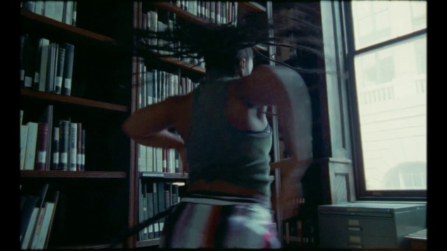 Video Reference: Snapshot, Window, Muscle, Daylighting, Photography, Glass, Fictional character, Darkness, Art, Person, Indoor, Shelf, Book, Room, Living, Television, Library, Man, Sitting, Table, Small, Computer, Screen, Laptop, Holding, Cat, Standing, Video, Remote, White, Playing, Text