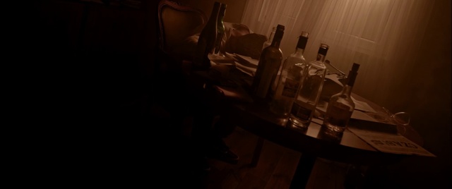 Video Reference: Black, Darkness, Light, Snapshot, Drinkware, Room, Wine glass, Glass, Still life photography, Photography, Indoor, Table, Sitting, Dark, Laptop, Computer, Woman, White, Desk, Lit, Man, Laying, Bed, Standing, Holding, Red, Kitchen, Bottle, Drink, Wine