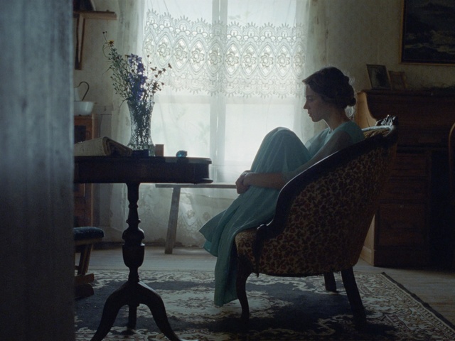 Video Reference: Sitting, Chair, Furniture, Human, Room, Reading, House, Tints and shades, Conversation, Person