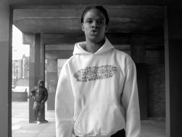 Video Reference: White, Photograph, Black, Standing, Outerwear, Snapshot, Black-and-white, Fashion, T-shirt, Human