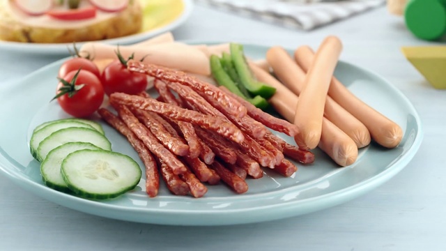 Video Reference: Dish, Food, Cuisine, Ingredient, Meat, Asparagus, Produce, Cabanossi, Vienna sausage, Recipe, Plate, Table, Sitting, White, Different, Small, Sliced, Topped, Black, Fruit, Salad, Green, Pink, Fast food, Sausage, Cervelat, Kielbasa, Bratwurst, Sujuk, Breakfast sausage, Diot, Knackwurst, Carrot, Andouille, Thuringian sausage, Loukaniko, Longaniza, Seafood, Italian sausage, Pork, Bologna sausage, Saucisson de lyon, Frankfurter wa14rstchen, Chistorra, Curing, Chorizo, Red meat, Animal fat, Root vegetable, Roasting, Bacon, Mettwurst, Bockwurst, Salami, Salchicha3n, Debrecener, Morteau sausage, German food, Goat meat, Boudin, Flat iron steak, Bierwurst, Churrasco food, Sobrassada, Veal, Skewer, Mixed grill, Beef, Roast beef, Ciauscolo, Steak, Kishka, Baby carrot, Cucumber, Pastrami, Soppressata, Cumberland sausage, Boerewors, Andouillette, Delicacy, Fuet, Meat chop, Delmonico steak, Charcuterie, Carne asada, Vegetable, Corned beef, Staple food, French fries, Lincolnshire sausage, Brisket, Lamb and mutton, Grilling, Potato, Brochette, Containing, Meal, Arranged