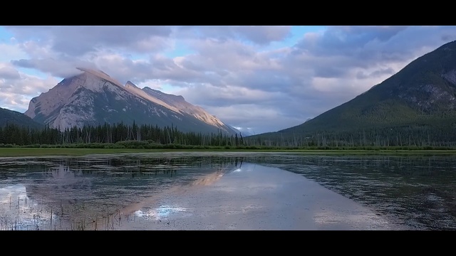 Video Reference: reflection, nature, sky, highland, mountain, mountainous landforms, wilderness, water, cloud, lake