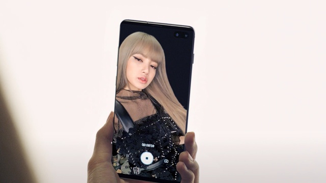 Video Reference: Gadget, Technology, Electronic device, Photography, Material property, Selfie, Mobile phone, Electronics, Black hair, Communication device, Person, Holding, Photo, Looking, Man, Front, Cellphone, Posing, Phone, Black, Woman, Clock, Hand, Wearing, Face, Standing, Young, Screen, Computer, Light, Human face, Fashion accessory, Girl, Clothing