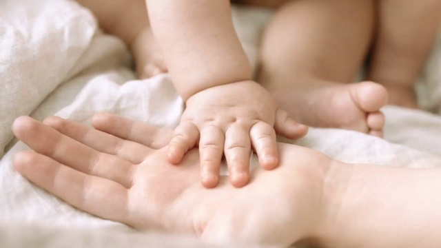 Video Reference: mother, hand, born, care, skin, leg, body, healing, hands, finger, health, human, massage