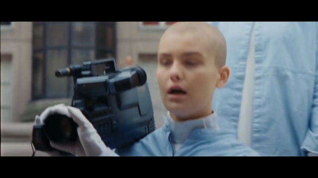 Video Reference: Hairstyle, Photography, Camera operator, Videographer, Camera, Cinematographer, Photo caption, Cameras & optics, Gun, Movie, Person