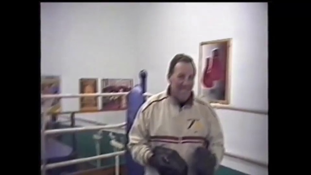 Video Reference: Photograph, Snapshot, Arm, Standing, Lecture, Fun, Muscle, Shoulder, Room, Window, Person, Indoor, Front, Wearing, Man, Black, Woman, White, Holding, Table, Smiling, Kitchen, Young, Bed, Clothing