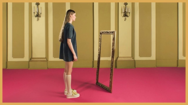 Video Reference: Yellow, Shoulder, Leg, Standing, Joint, Arm, Human body, Room, Floor, Knee, Person, Indoor, Woman, Man, Front, Young, Red, Holding, Building, Mirror, Girl, Wearing, Door, Phone, Suit, Walking, Playing, Rug, Suitcase, White, Wall, Footwear, Dress, Skirt, Clothing, Miniskirt, Handbag, Furniture