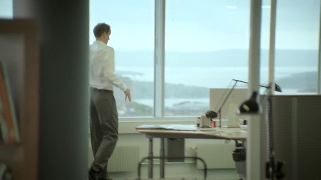 Video Reference: furniture, room, window, standing, interior design, office, daylighting, glass, Person