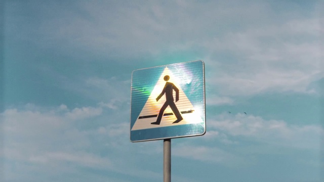 Video Reference: Sky, Signage, Sign, Advertising, Road, Display advertising, Pedestrian, Billboard, Traffic sign, Outdoor, Street, Cloudy, Clouds, Blue, Water, Close, Green, Large, Ocean, White, Standing, Beach, City, Traffic, Text, Person, Cloud, Day