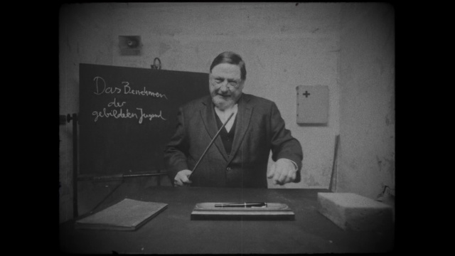 Video Reference: Photograph, Text, Snapshot, Portrait, Standing, Photography, Public speaking, Monochrome photography, Font, Black-and-white