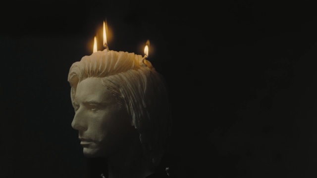 Video Reference: Candle, Lighting, Head, Darkness, Flame, Still life photography, Interior design, Looking, Holding, Man, Standing, Glass, Front, Dark, Woman, White, Black, Table, Room, Water, Shirt, Umbrella, Light