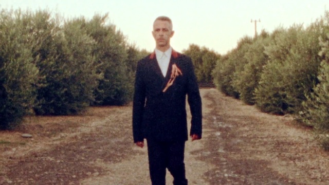 Video Reference: Photograph, Standing, Suit, Formal wear, Outerwear, Tree, Photography, Smile, Tuxedo