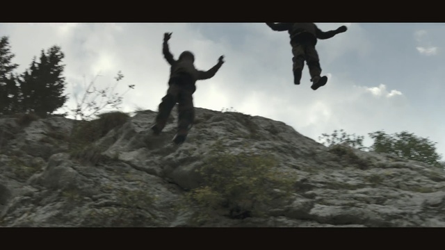 Video Reference: extreme sport, sky, jumping, adventure, outdoor recreation, mountain, rock, terrain, ridge, geological phenomenon, Person