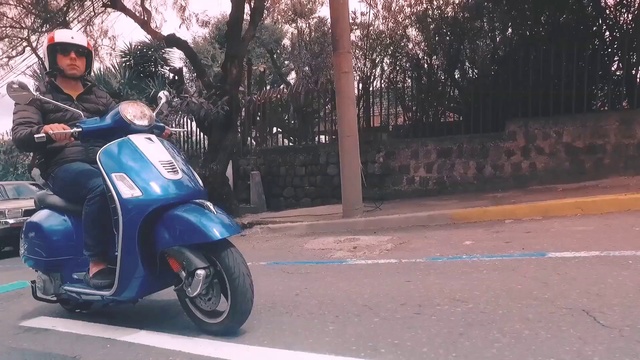 Video Reference: Land vehicle, Vehicle, Scooter, Mode of transport, Vespa, Wheel, Motorcycle, Automotive wheel system, Car, Asphalt
