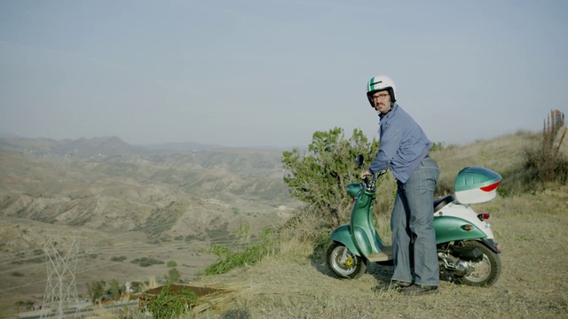 Video Reference: Vehicle, Scooter, Mode of transport, Ecoregion, Grass, Vespa, Soil, Landscape, Plant, Hill station