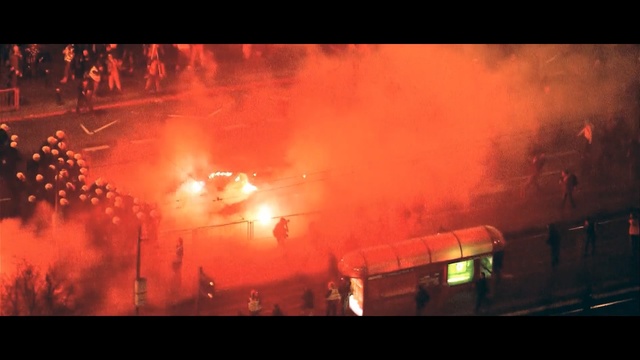 Video Reference: Red, Fire, Smoke, Heat, Sky, Event, Explosion, Wildfire, Flare, Evening, Outdoor, Train, Track, Dark, Street, Clouds, Traveling, Bright, Sun, Sunset, Large, Traffic, Driving, Bus, Light, Water, Orange, City, Lot, Stop, Yellow, Steam, Highway, Blurry, Night, Riding, Parked, Fireworks, Text, Firefighter