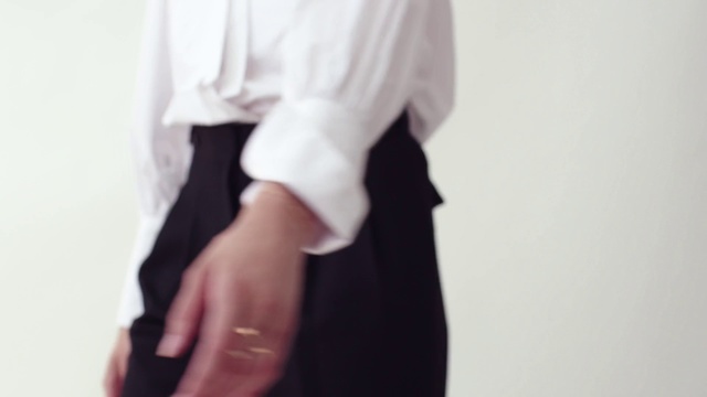 Video Reference: White, Clothing, Neck, Shoulder, Outerwear, Sleeve, Collar, Formal wear, Dress, Blouse