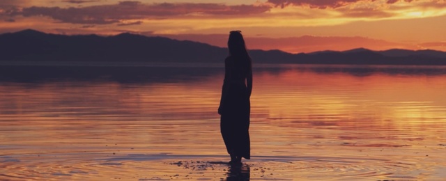 Video Reference: sky, sunrise, calm, reflection, sunset, horizon, physical fitness, evening, sunlight, water, Person