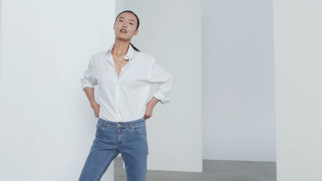Video Reference: clothing, white, standing, shoulder, jeans, sleeve, fashion model, denim, shirt, dress shirt, Person