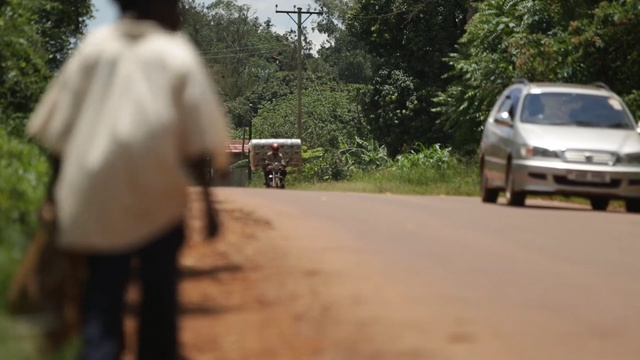 Video Reference: road, car, vehicle, mode of transport, infrastructure, path, transport, tree, family car, motor vehicle, Person