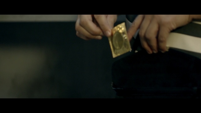 Video Reference: black, green, yellow, string instrument, finger, hand, fashion accessory, darkness, sitting, photography