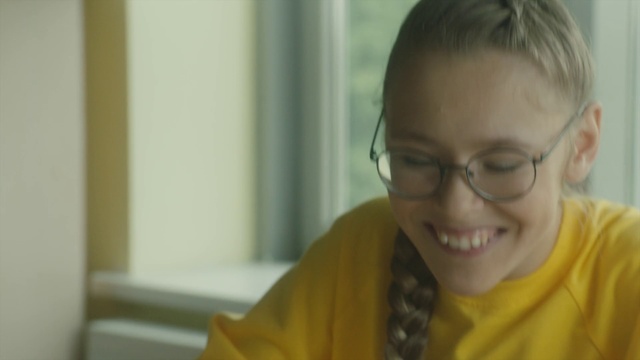 Video Reference: Hair, Face, Facial expression, Glasses, Child, Nose, Smile, Skin, Head, Yellow