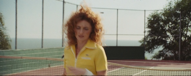 Video Reference: Tennis court, Sport venue, Racket, Tennis equipment, Tennis, Net, Lady, Racquet sport, Strings, Tennis racket accessory, Person, Outdoor, Game, Woman, Court, Holding, Young, Standing, Yellow, Hand, Girl, Playing, Player, White, Red, Man, Athletic game, Sport, Human face, Clothing