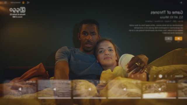 Video Reference: Photography, Screenshot, Person, Indoor, Woman, Table, Sitting, Food, Front, Man, Doughnut, Holding, Donut, Young, Restaurant, Plate, Large, People, Text, Human face