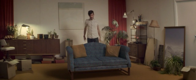 Video Reference: room, furniture, interior design, couch, living room, home, flooring, house, window, chair, Person