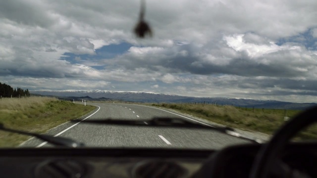 Video Reference: Sky, Road, Cloud, Windshield, Highland, Road trip, Mode of transport, Infrastructure, Glass, Window