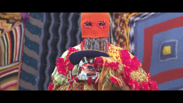 Video Reference: Red, Entertainment, Magenta, Fashion design, Art, Event, Performing arts, Hat, Tradition, Fur