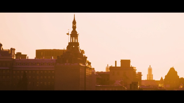 Video Reference: Landmark, City, Sky, Metropolitan area, Atmospheric phenomenon, Metropolis, Spire, Morning, Yellow, Human settlement, Person