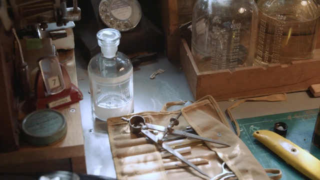 Video Reference: glass bottle, glass, table, Person