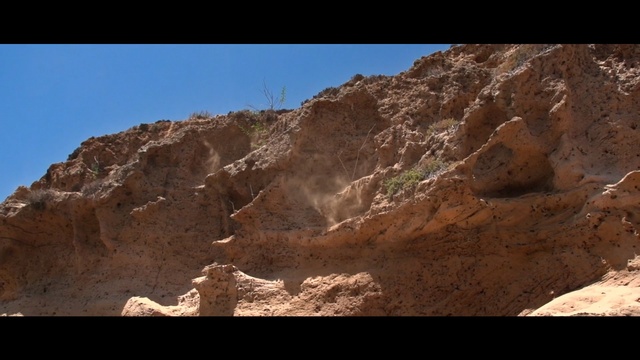 Video Reference: Rock, Badlands, Formation, Outcrop, Mountainous landforms, Bedrock, Geology, Geological phenomenon, Wadi, Soil, Mountain, Nature, Outdoor, Valley, Rocky, Side, Hill, Standing, Man, Air, Skiing, Walking, Slope, Covered, Giraffe, Doing, Tall, White, Blue, Plane, Desert, Cave, Canyon, Makhtesh, Sky, Hillside