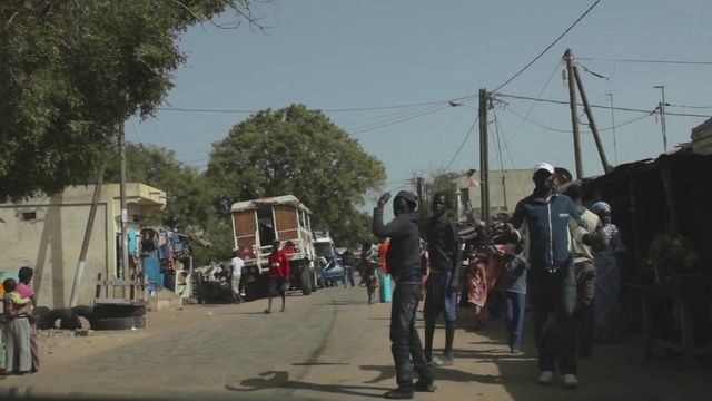 Video Reference: Town, Street, Pedestrian, Tree, Neighbourhood, Road, Crowd, Thoroughfare, Compact car, Electricity