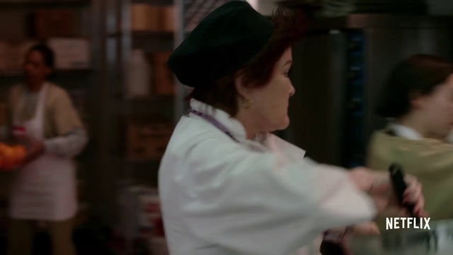 Video Reference: Chef, Fun, Headgear, Costume, Event, Tradition, Ceremony, Person, Indoor, Man, Woman, Holding, Looking, Standing, Young, Front, Table, Wearing, Shirt, People, Girl, White, Food, Kitchen, Room, Blurry, Playing, Video, Red, Computer, Pizza, Hat, Human face, Fashion accessory, Clothing
