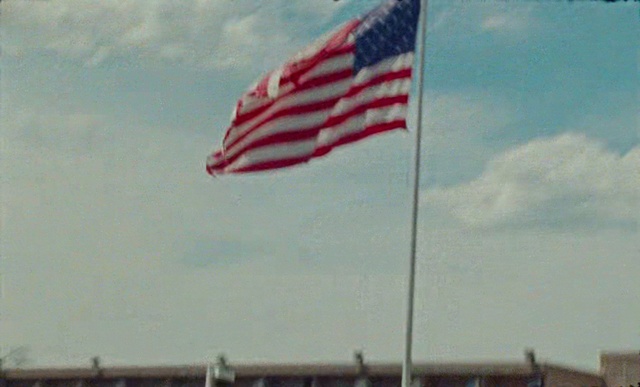 Video Reference: Flag, Flag of the united states, Sky, Cumulus, Cloud, Flag day (usa), Wind, Outdoor, Water, Flying, Plane, Airplane, Large, Boat, View, Cloudy, Kite, Mountain, White, Red, Field, Air, Body, Ocean, Blue, River, Docked, Group, People, City, Standing, Jet, Man, Runway, Tarmac, Beach, Tower, Sign, Street