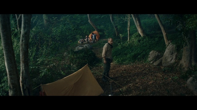 Video Reference: Jungle, Nature, Forest, Natural environment, Green, Woodland, Wilderness, Tree, Biome, Sunlight, Outdoor, Man, Standing, Riding, Young, Ramp, Doing, Tall, Holding, Board, Trick, White, Screenshot, Person