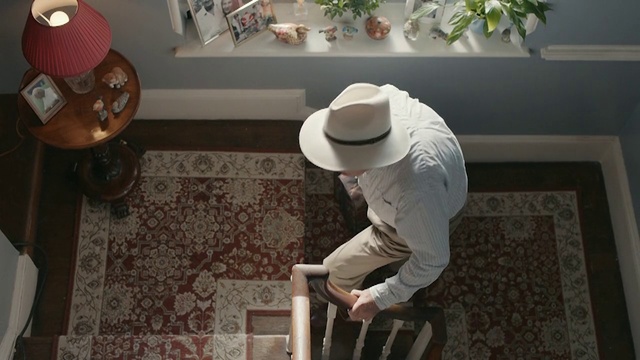 Video Reference: Floor, Headgear, Room, Hat, Flooring, Furniture, Interior design, Table, Tile, Fashion accessory