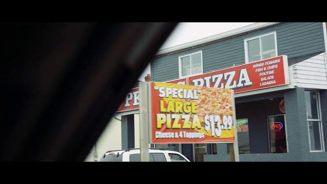 Video Reference: Text, Font, Building, Advertising, Fast food restaurant, Fast food, House, Signage, Facade, City, Outdoor, Sign, Front, Restaurant, Small, Store, Sitting, White, Street, Shop, Large, Red, Parked, Standing, Window, People, Train, Fire, Billboard, Car, Vehicle, Land vehicle