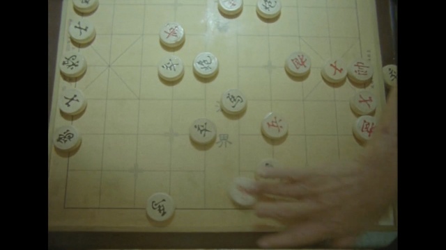 Video Reference: Text, Yellow, Games, Number, Square, Indoor games and sports, Tile, Person, Indoor, Photo, White, Light, Table, Sitting, Orange, Lit, Food, Curtain