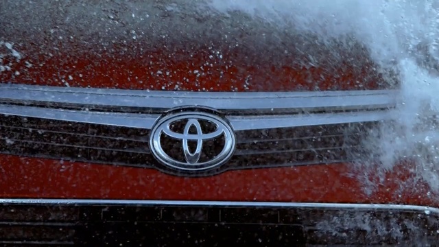 Video Reference: motor vehicle, red, car, automotive design, reflection, automotive exterior, vehicle, automotive lighting, hood, city car